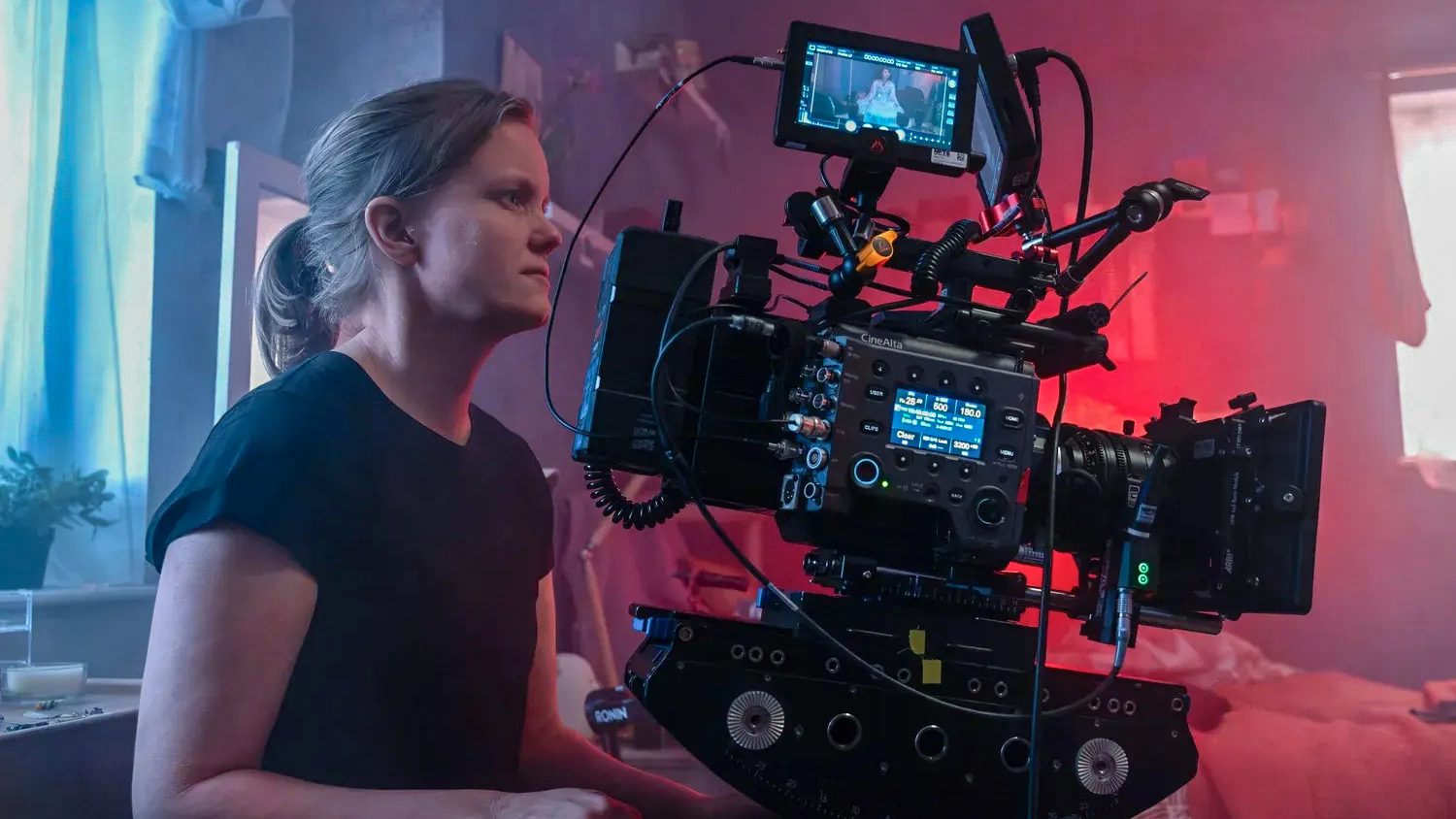 Jenni Suitiala using cinema camera indoors
