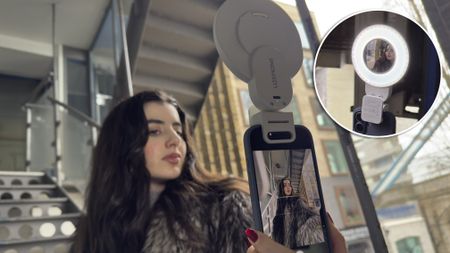 Shot of a model snapping a selfie from an iPhone&rsquo;s rear cameras (so she can&rsquo;t see its screen). She is looking at the mirror inserted into the middle of the LR30Bi ring light so that she can compose her selfie.