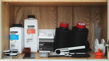 A selection of home film developing equipment and chemicals.