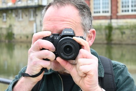 Man looking through Nikon Z50 II viewfinder